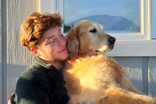 max holding a dog