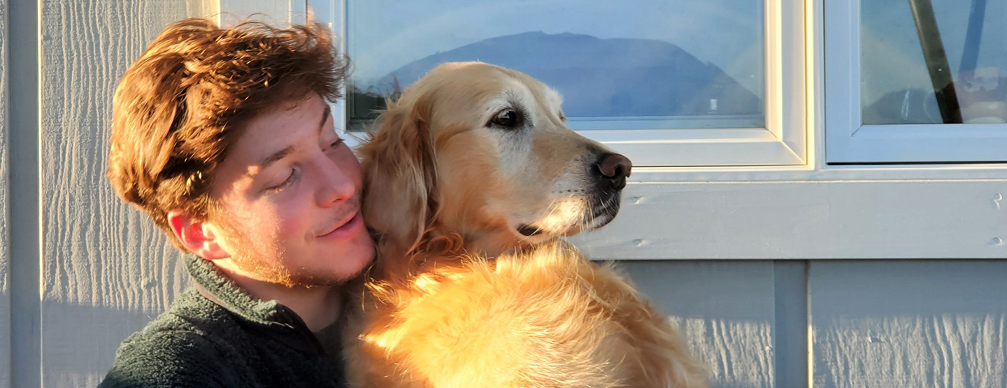 max holding a dog