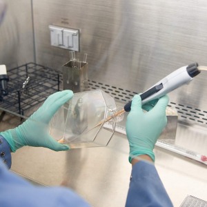 lab worker extracting a sample